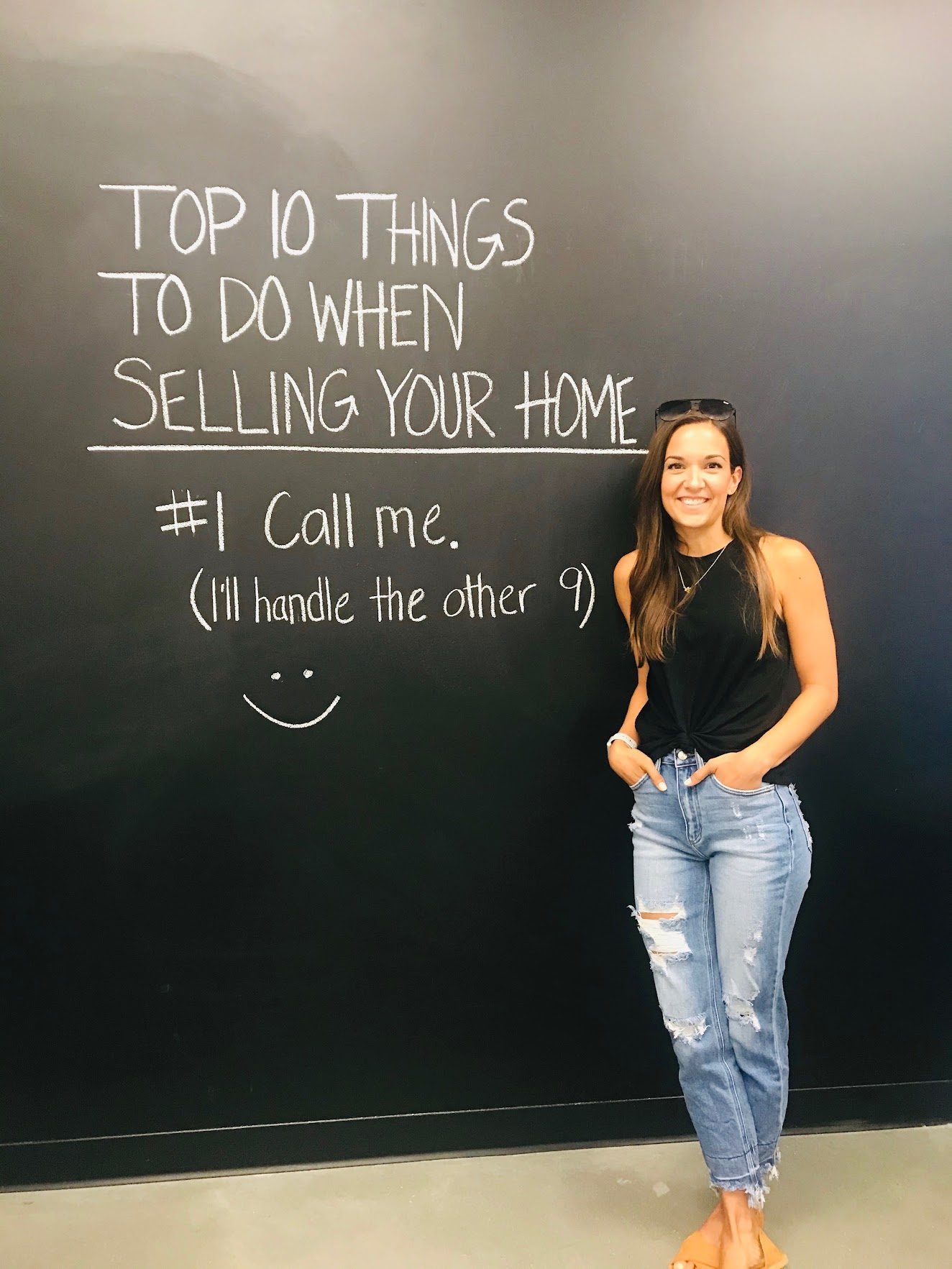 Agent smiling next to a chalkboard