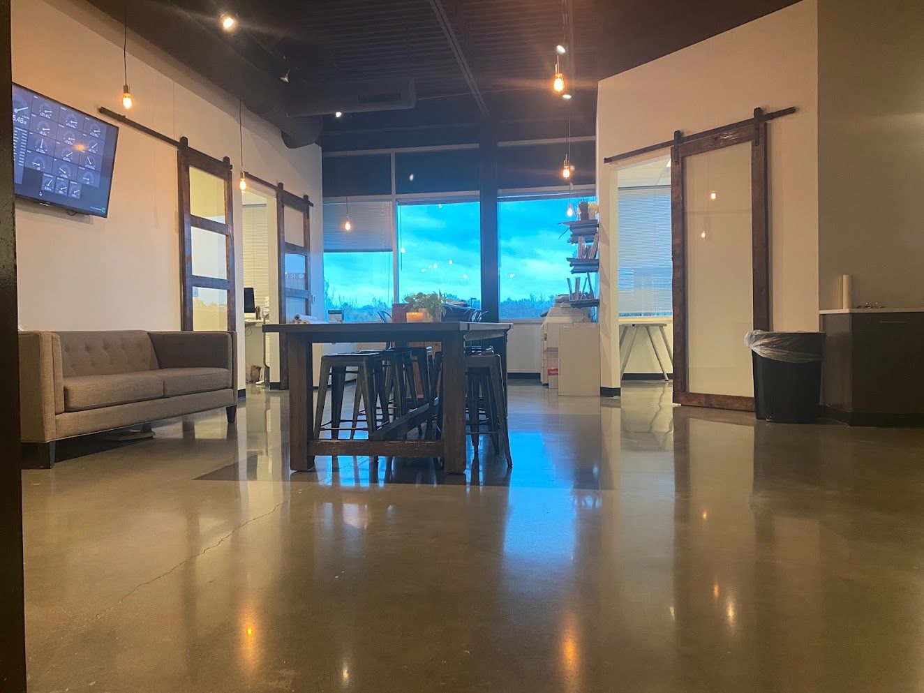 Office lounge with live production dashboard